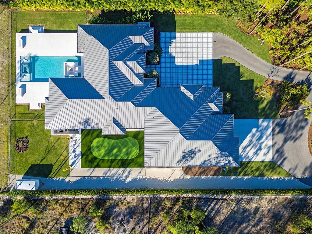 View from above of property with a pool, putting green, and Bocce