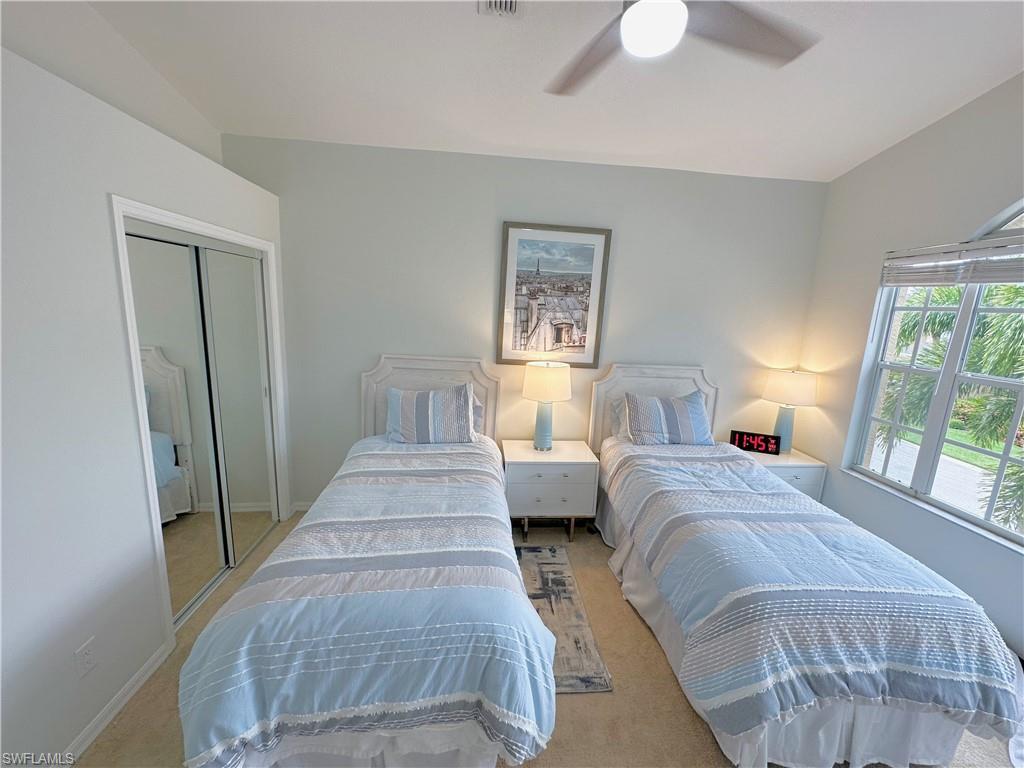 Bedroom featuring ceiling fan, a closet, and carpet flooring