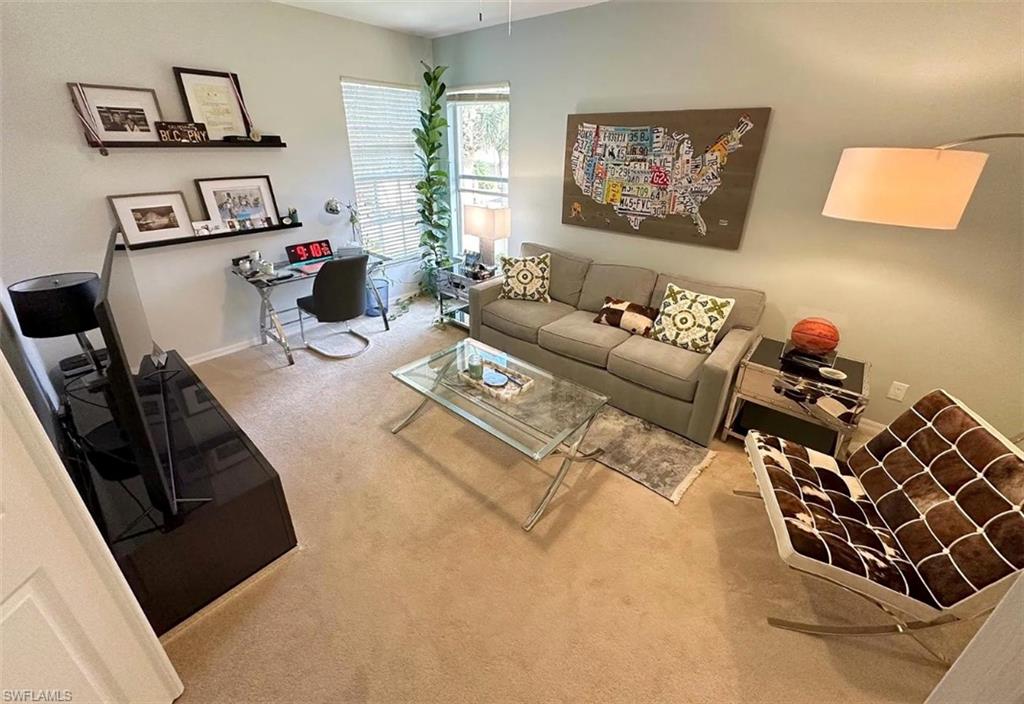 Living room with carpet and an office area