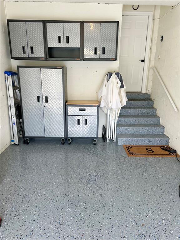 Mudroom featuring concrete block wall