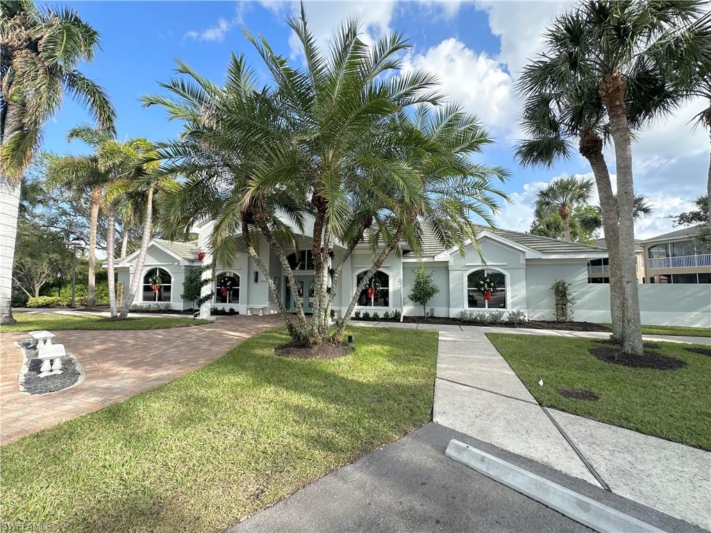 View of front of property featuring a front lawn and stucco siding