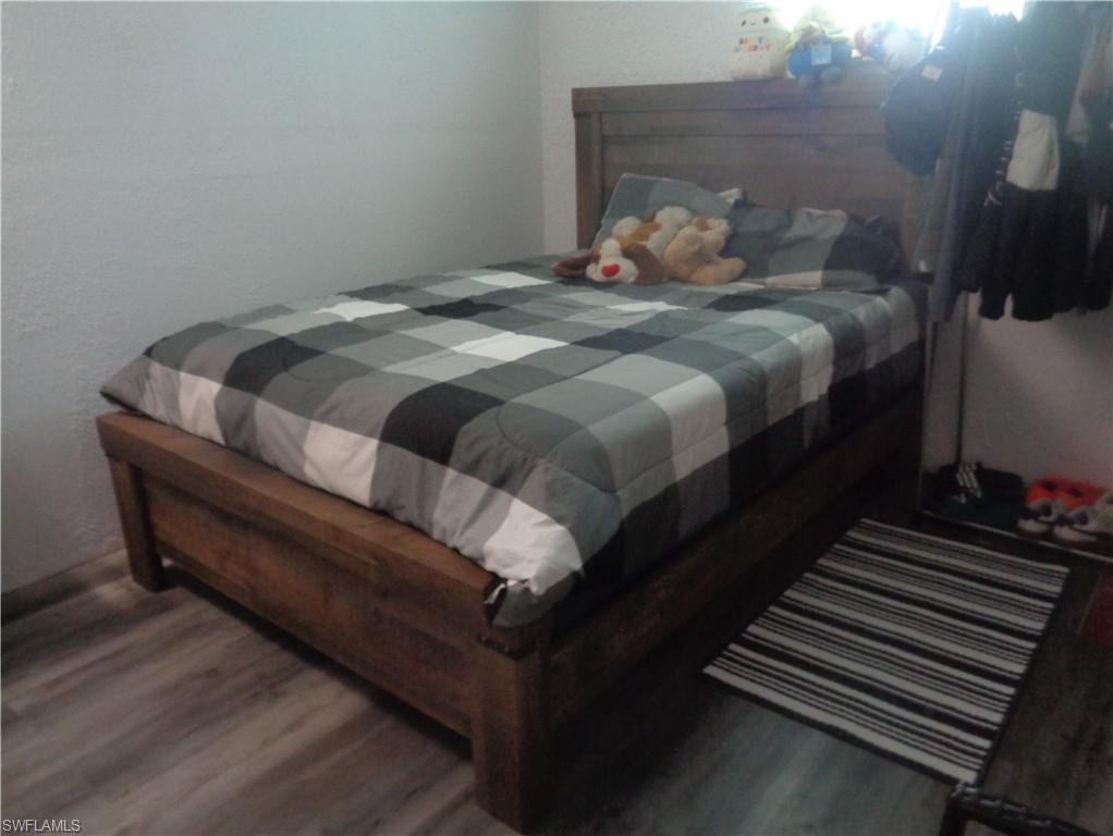 Additional bedroom with wood-type flooring