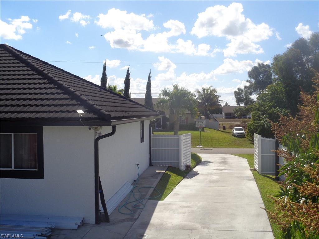 View of side of home with permitted second driveway accessing the property's back patio