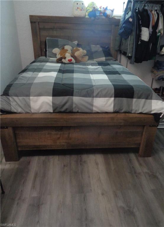 Additional bedroom featuring wood-type flooring