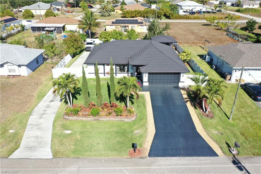 Aerial view of suburban area. Property has a double permitted driveway