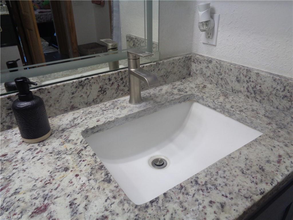 Master bedroom's bathroom featuring granite top and t vanity