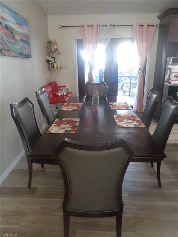 Dining area with light wood-type flooring and baseboards