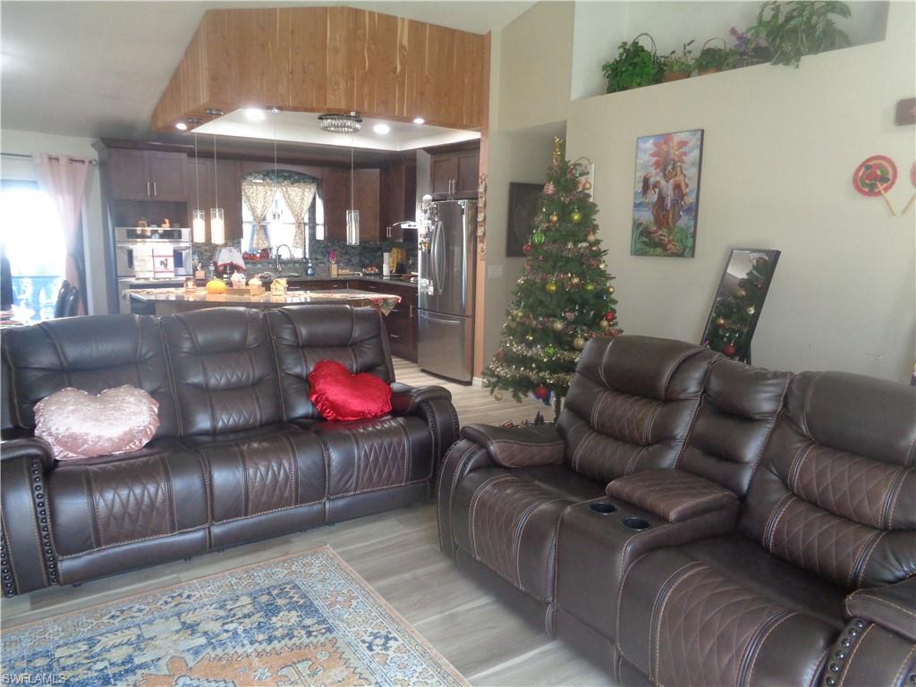 Living room with light wood-style floors and plenty of natural light