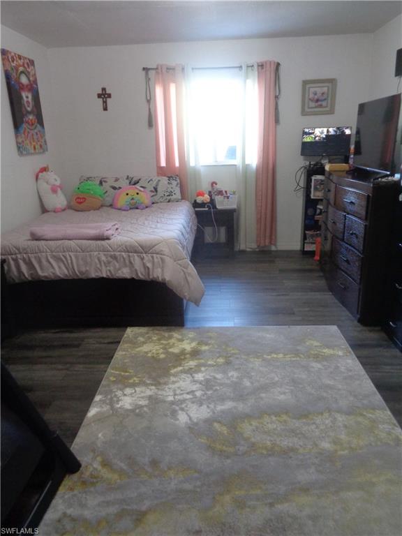 Master bedroom with dark wood finished floors