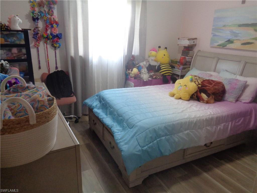 Guest bedroom 1 with light wood finished floors