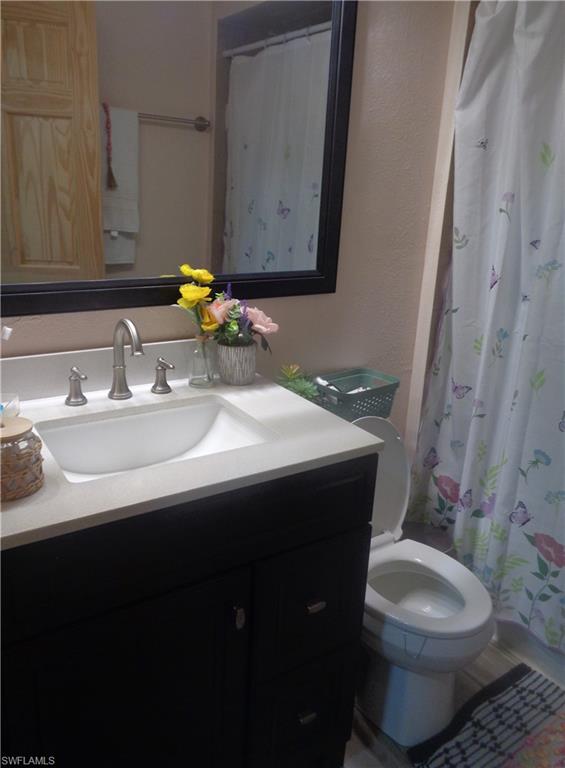 Bathroom 2 featuring curtained shower and vanity