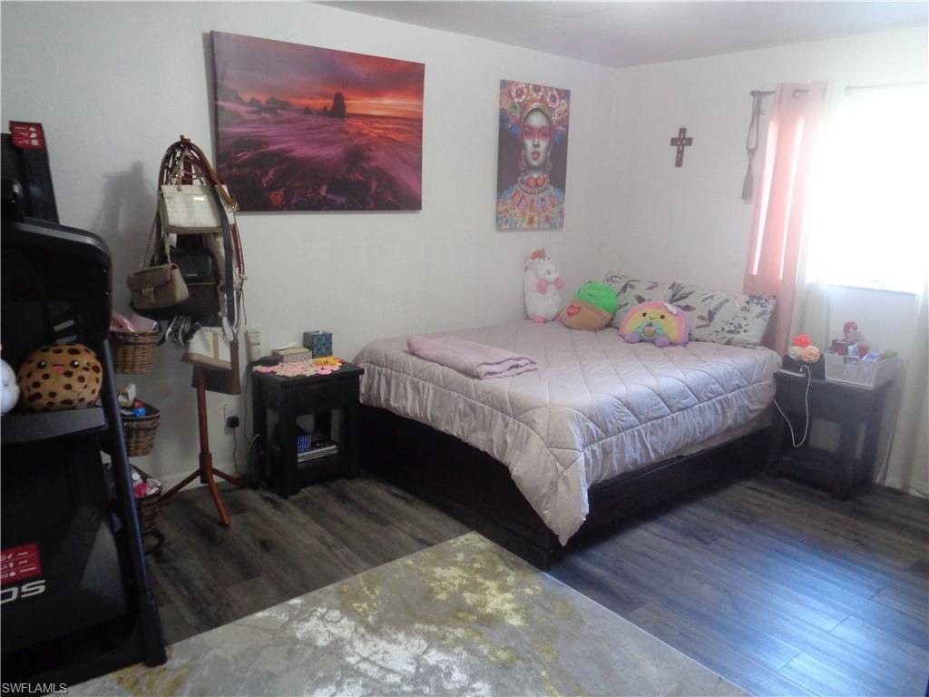Master bedroom featuring dark wood-style flooring