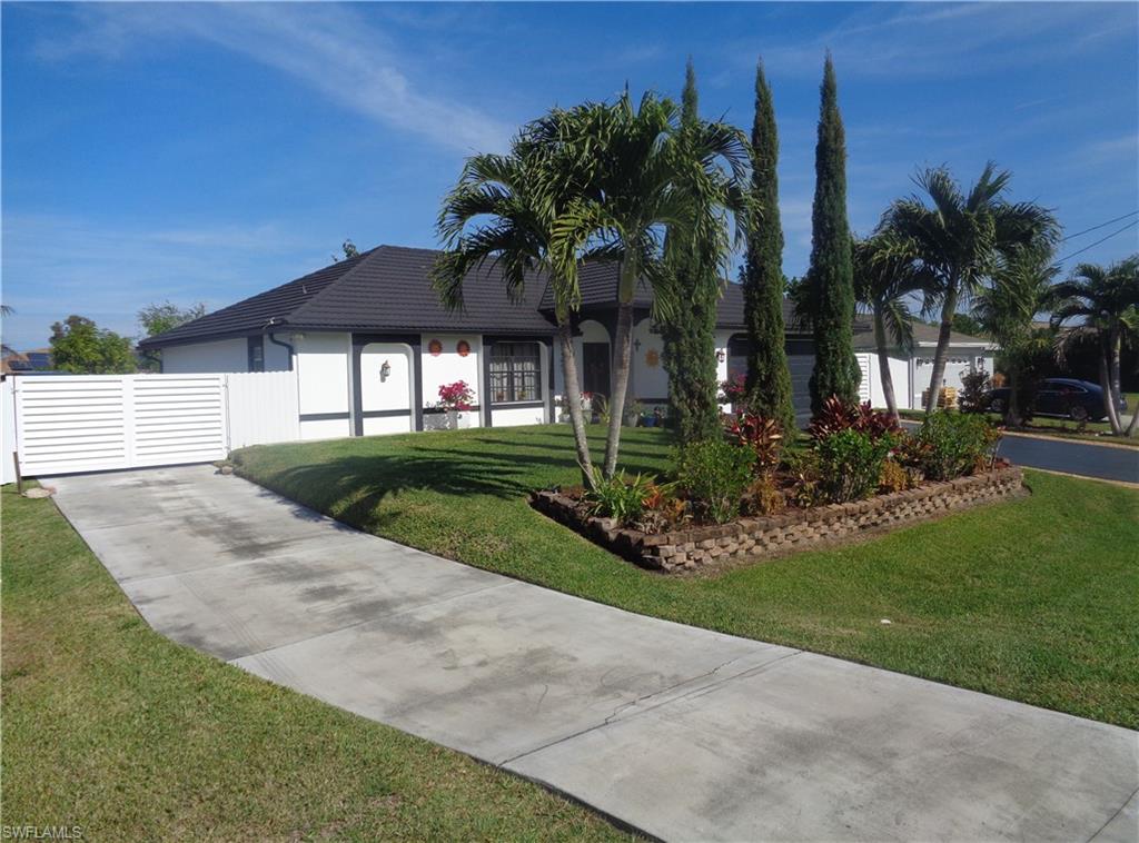 Left side view of single story home with stucco siding and a gate