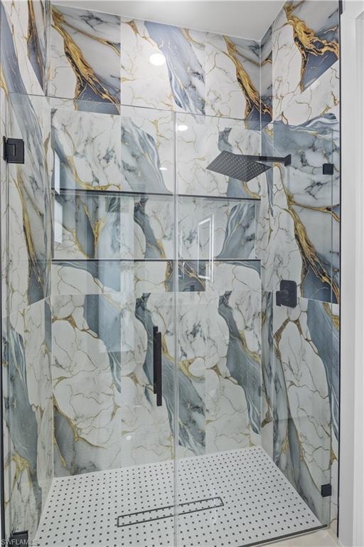 Bathroom featuring a marble finish shower