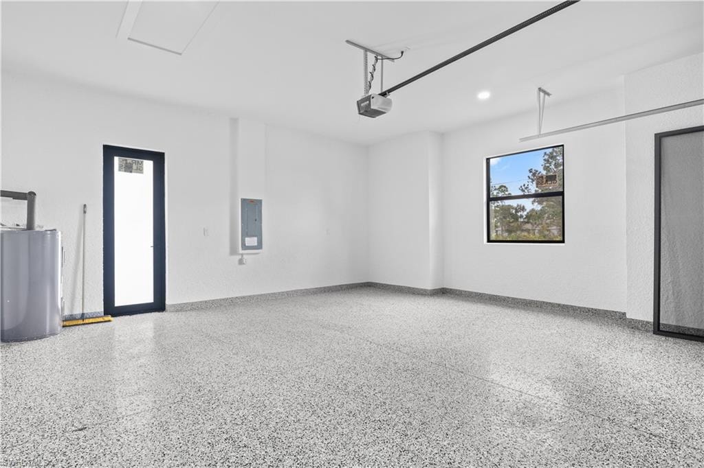 Garage featuring electric panel and recessed lighting