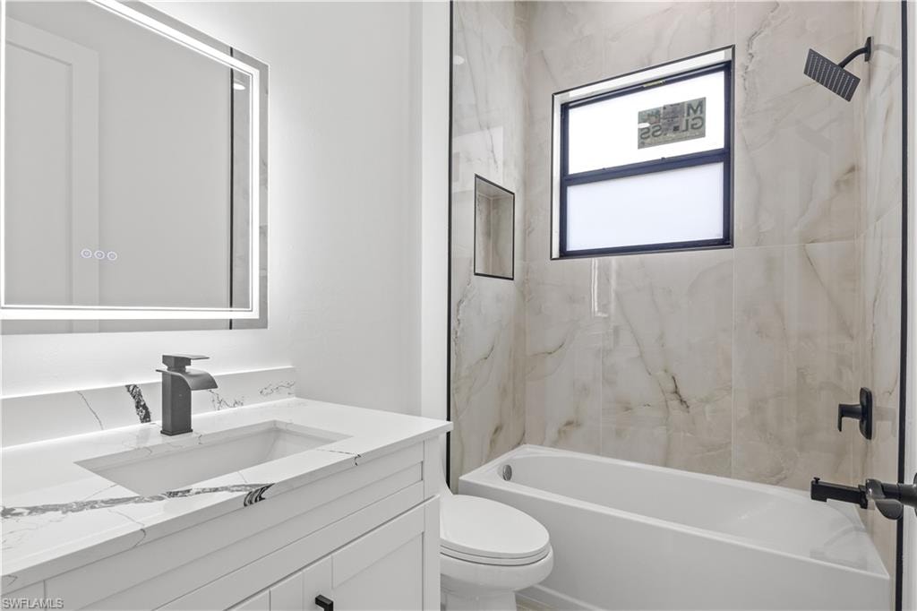 Bathroom with vanity and washtub / shower combination