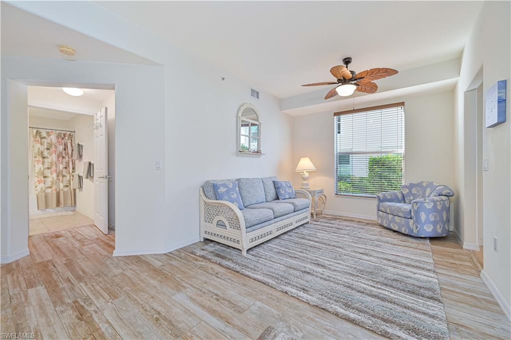 Living room featuring light wood finished floors and ceiling fan