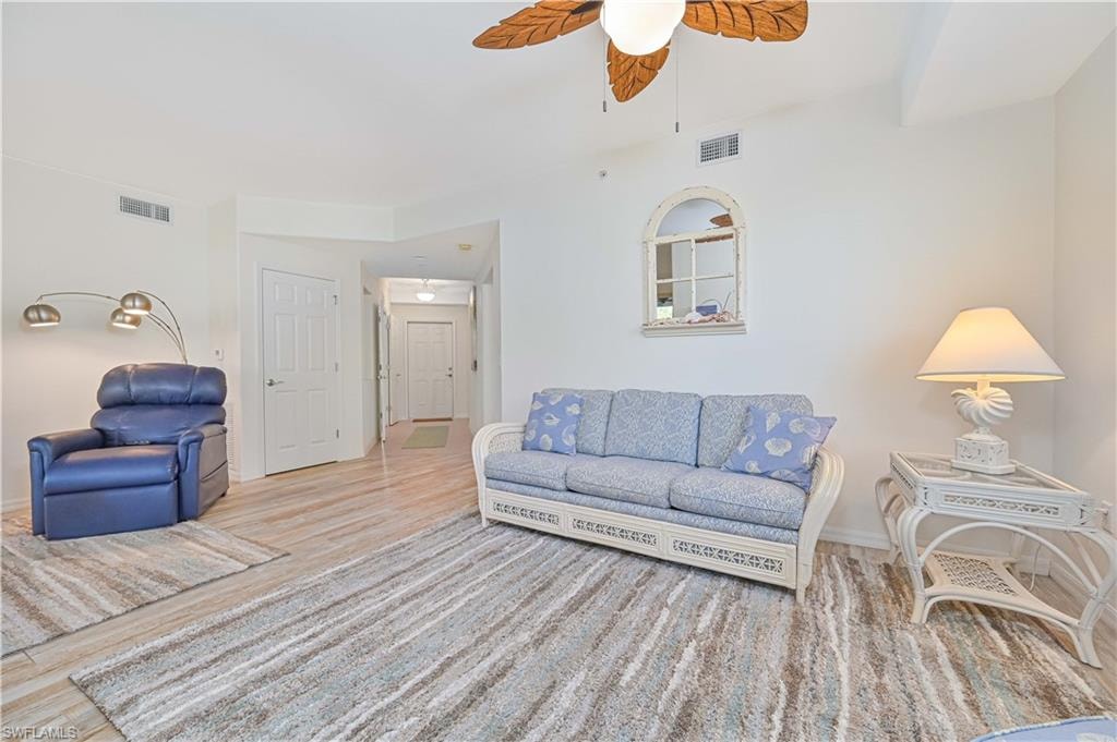 Living area featuring wood finished floors and a ceiling fan