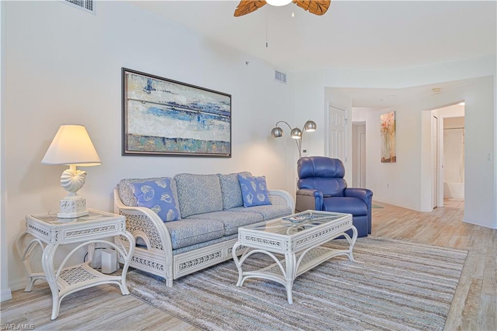 Living area with light wood-style flooring and a ceiling fan