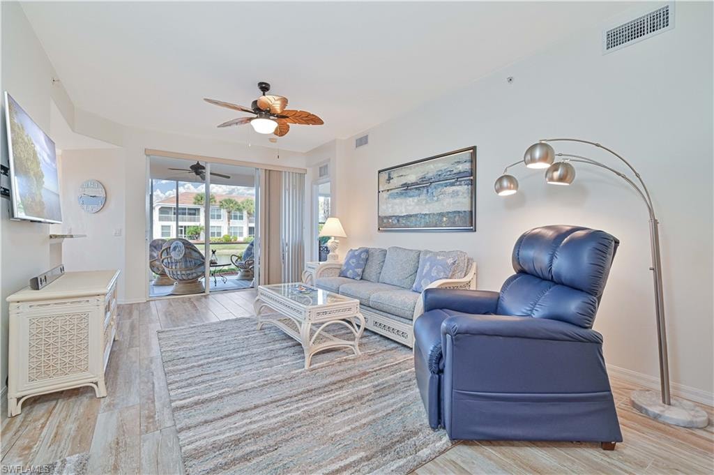 Living room with light wood-style flooring and ceiling fan