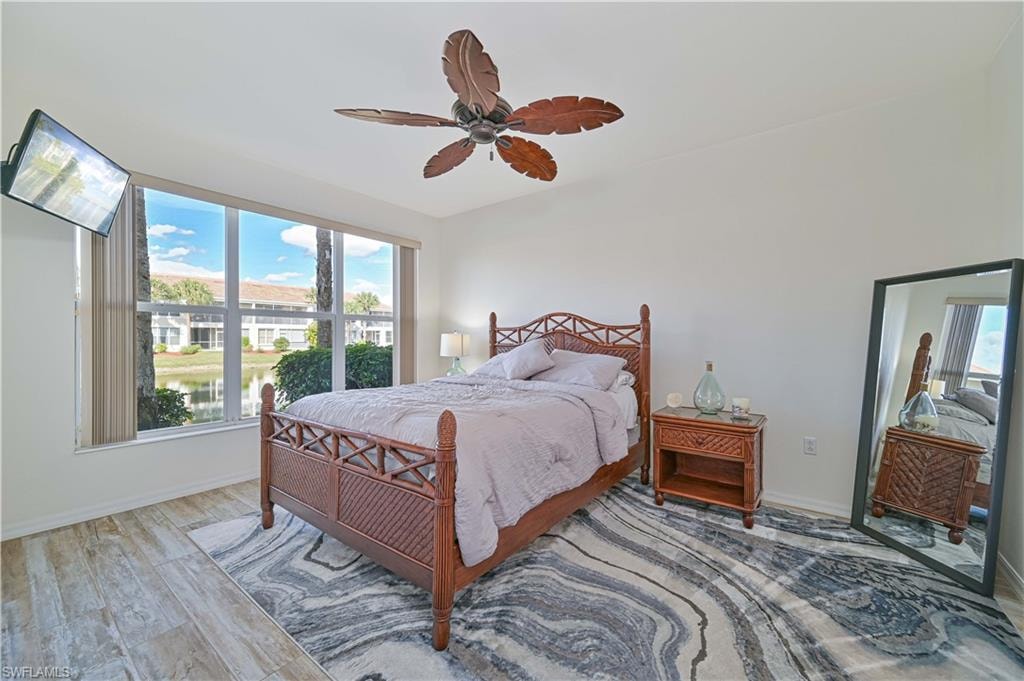 Bedroom with wood finished floors and a ceiling fan