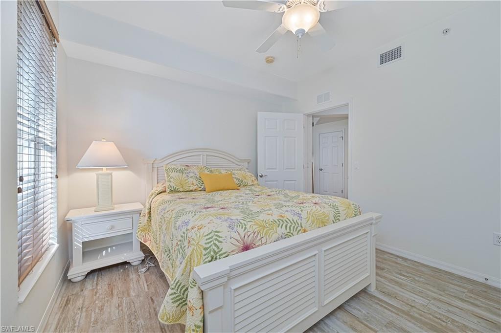 Bedroom with a ceiling fan and light wood-type flooring