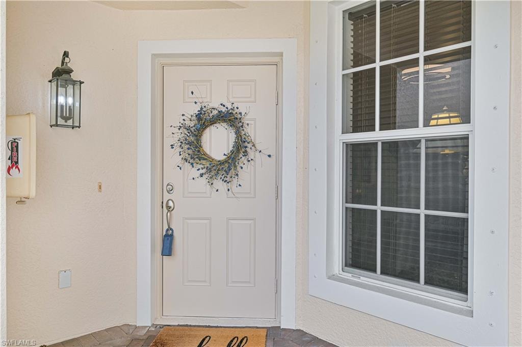 Entrance to property featuring stucco siding