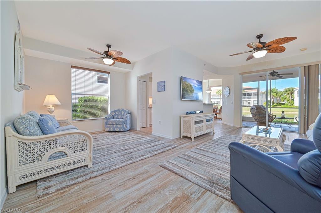 Living room featuring ceiling fan and light wood-style floors