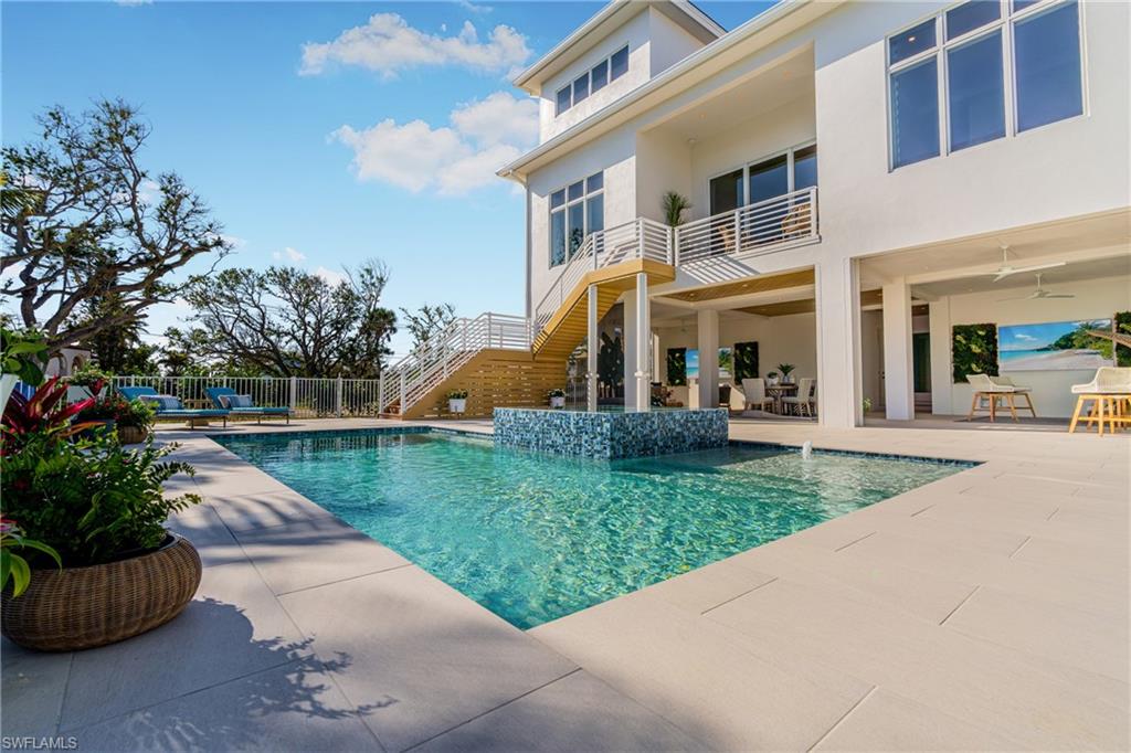View of swimming pool with stairway, a patio area, a balcony, and outdoor dining area