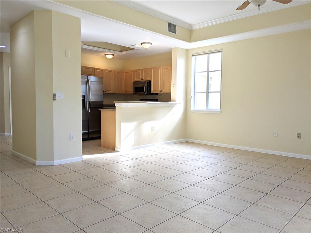 Kitchen with stainless steel appliances, ornamental molding, ceiling fan, a peninsula, and open floor plan