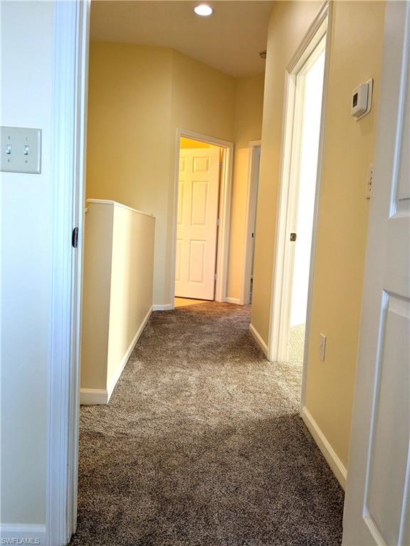 Hall featuring carpet flooring and recessed lighting