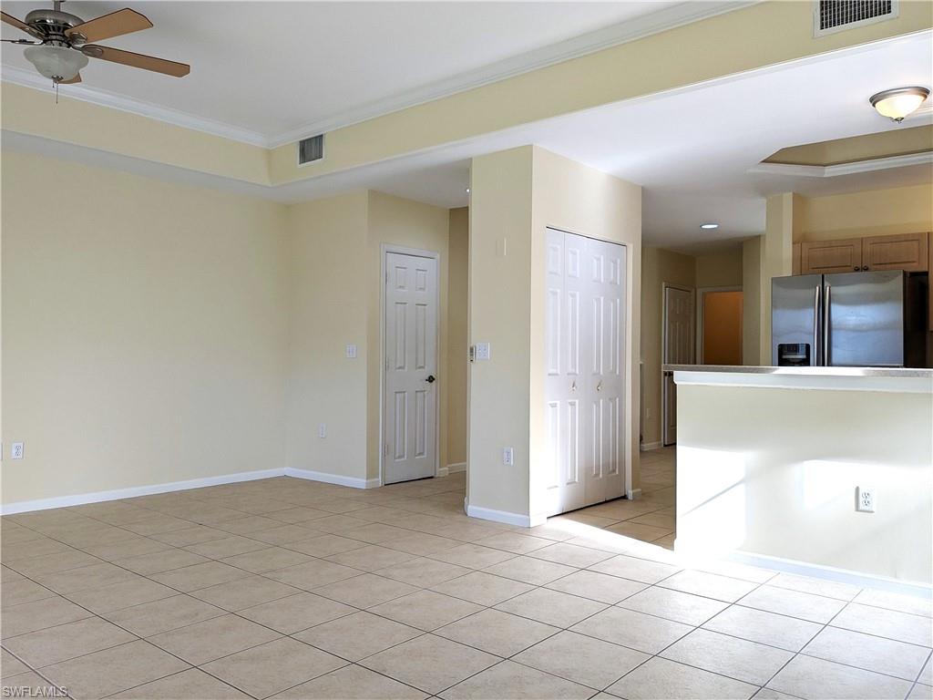 Empty room featuring ornamental molding and light tile patterned floors