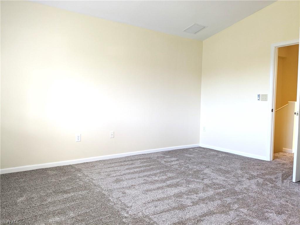 Unfurnished room with dark colored carpet