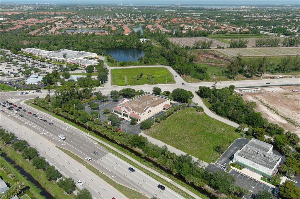 Aerial perspective showcasing commercial properties alongside a multi-lane highway