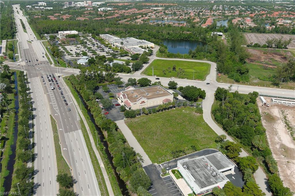 Expansive commercial parcel featuring clear ground and mature trees