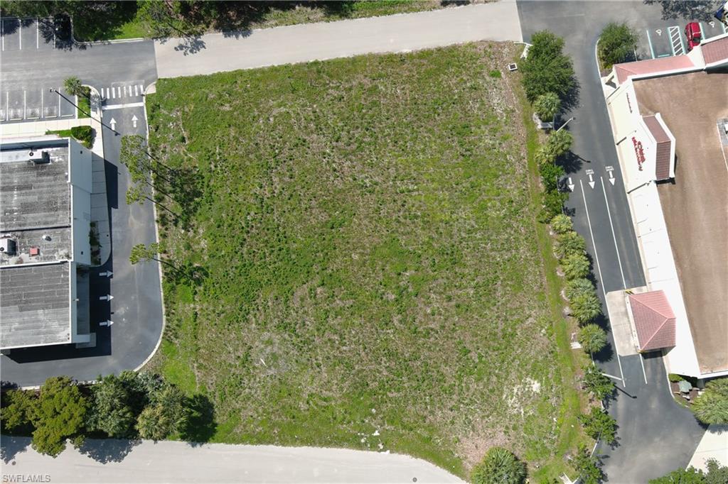 Expansive undeveloped lot featuring a natural ground cover and perimeter landscaping
