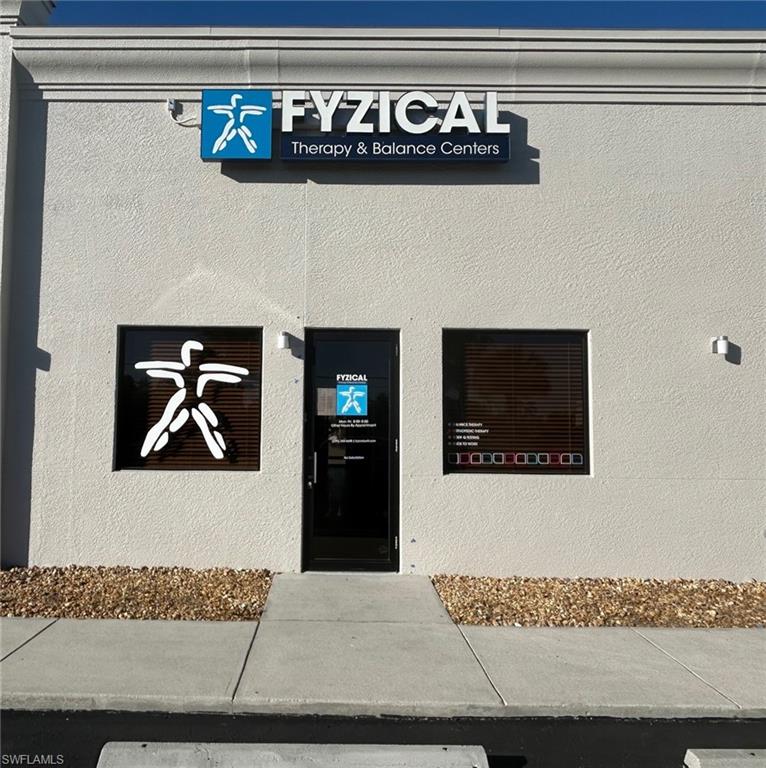Entrance to property featuring stucco siding