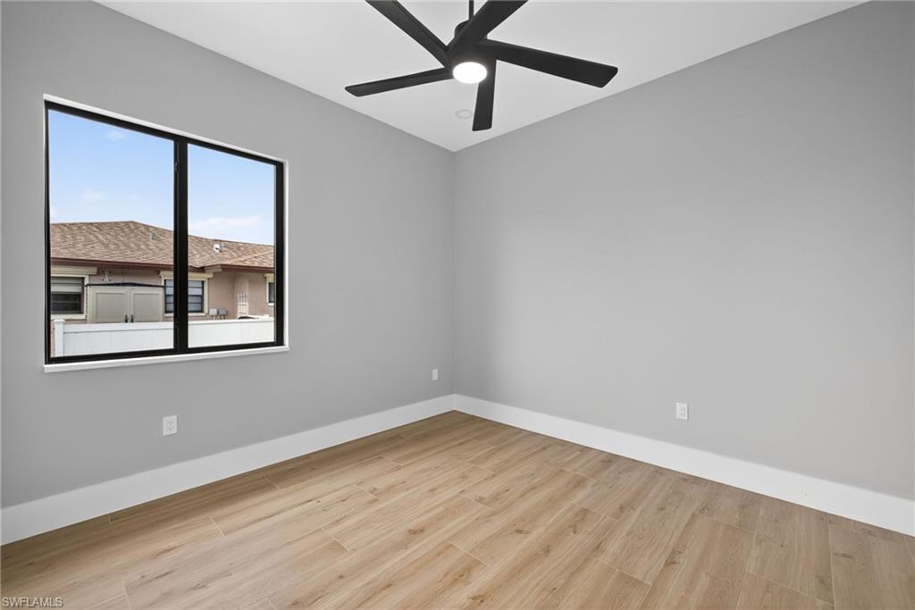 Spare room featuring light wood-type flooring and ceiling fan