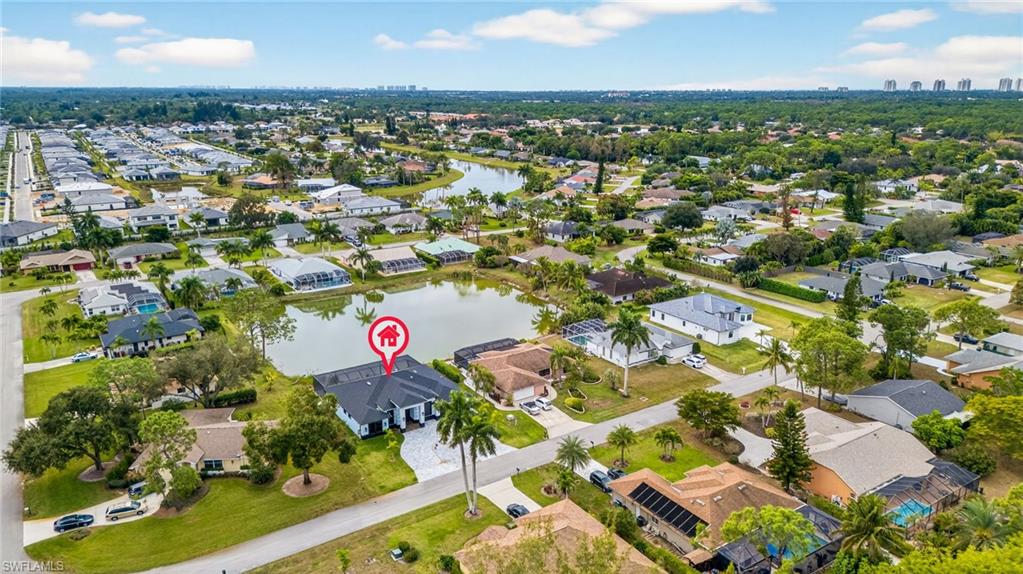 Aerial overview of property's location with nearby suburban area and a large body of water