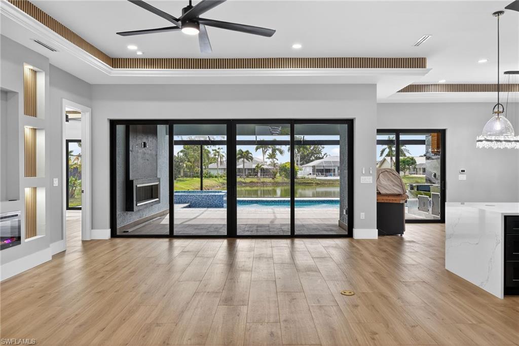 Unfurnished living room featuring light wood finished floors and ceiling fan