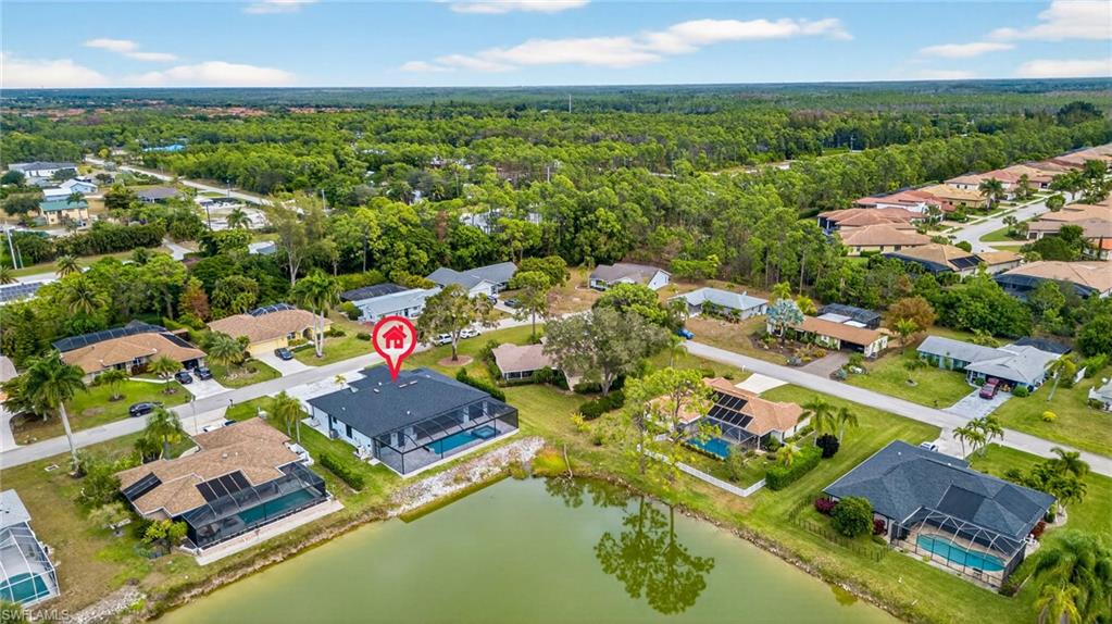 Aerial view of property's location featuring nearby suburban area and a nearby body of water