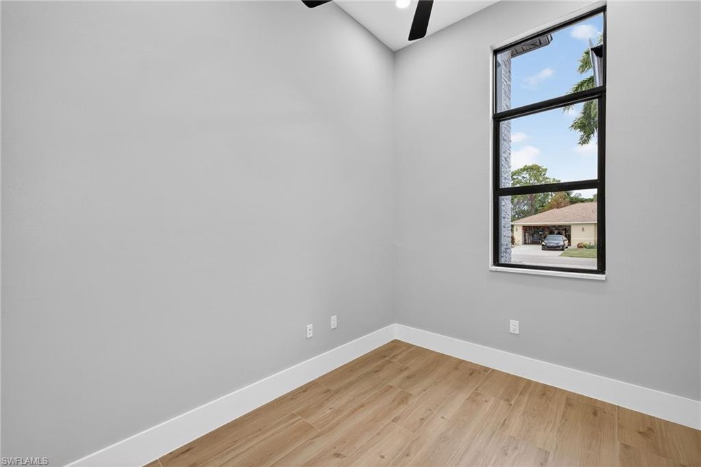 Spare room featuring light wood-style floors, a ceiling fan, and recessed lighting