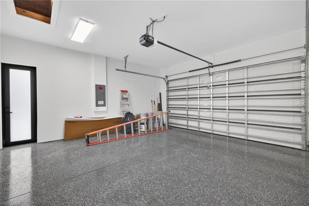 Garage with electric panel and a garage door opener