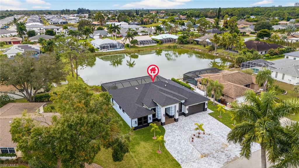Aerial perspective of suburban area featuring a large body of water