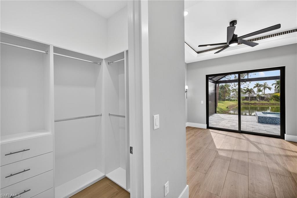 Walk in closet featuring light wood-style flooring and ceiling fan