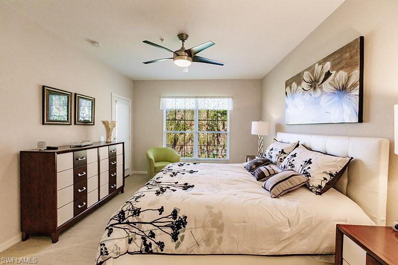 Carpeted bedroom featuring ceiling fan