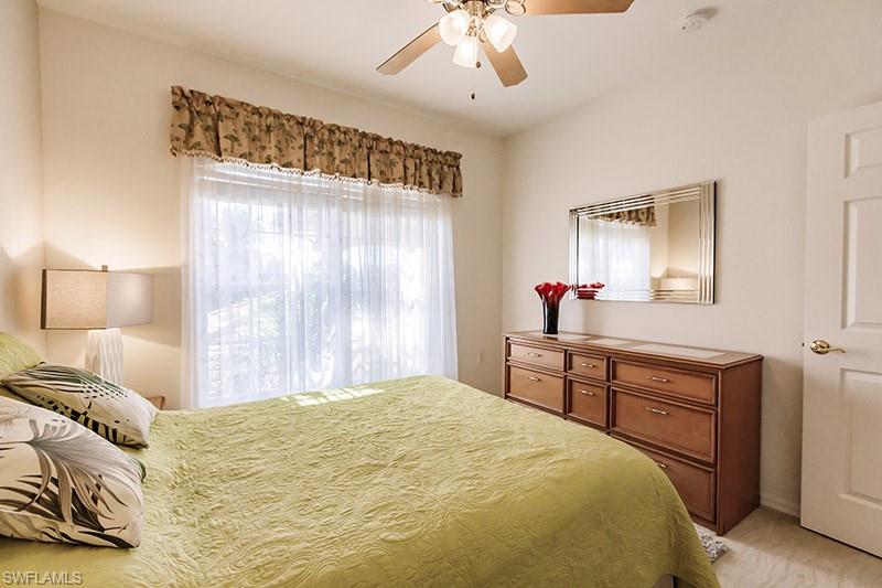 Carpeted bedroom with ceiling fan