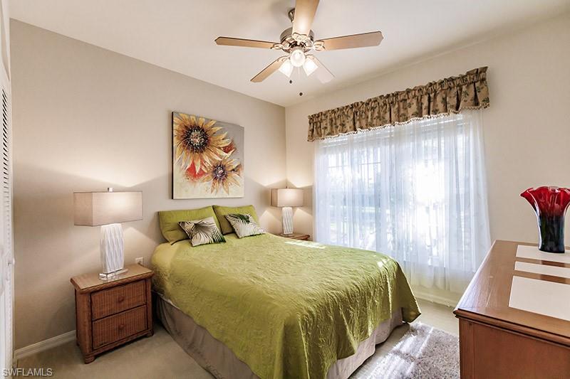 Carpeted bedroom featuring a closet and ceiling fan