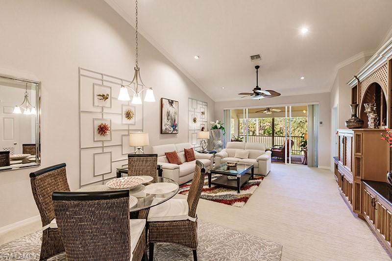 Dining area featuring ceiling fan, carpet flooring, high vaulted ceiling, and ornamental molding