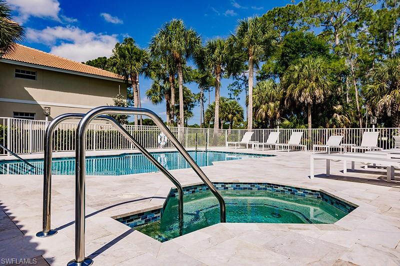 View of pool with a community hot tub and a patio